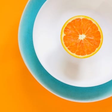 a half cut orange in a plate